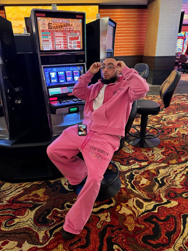 Customer in a pink Stay Ribelle sweatsuit in an arcade