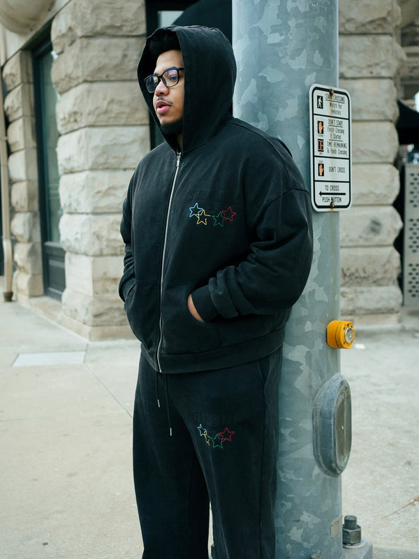 Customer in a black Stay Ribelle zip hoodie and matching pants
